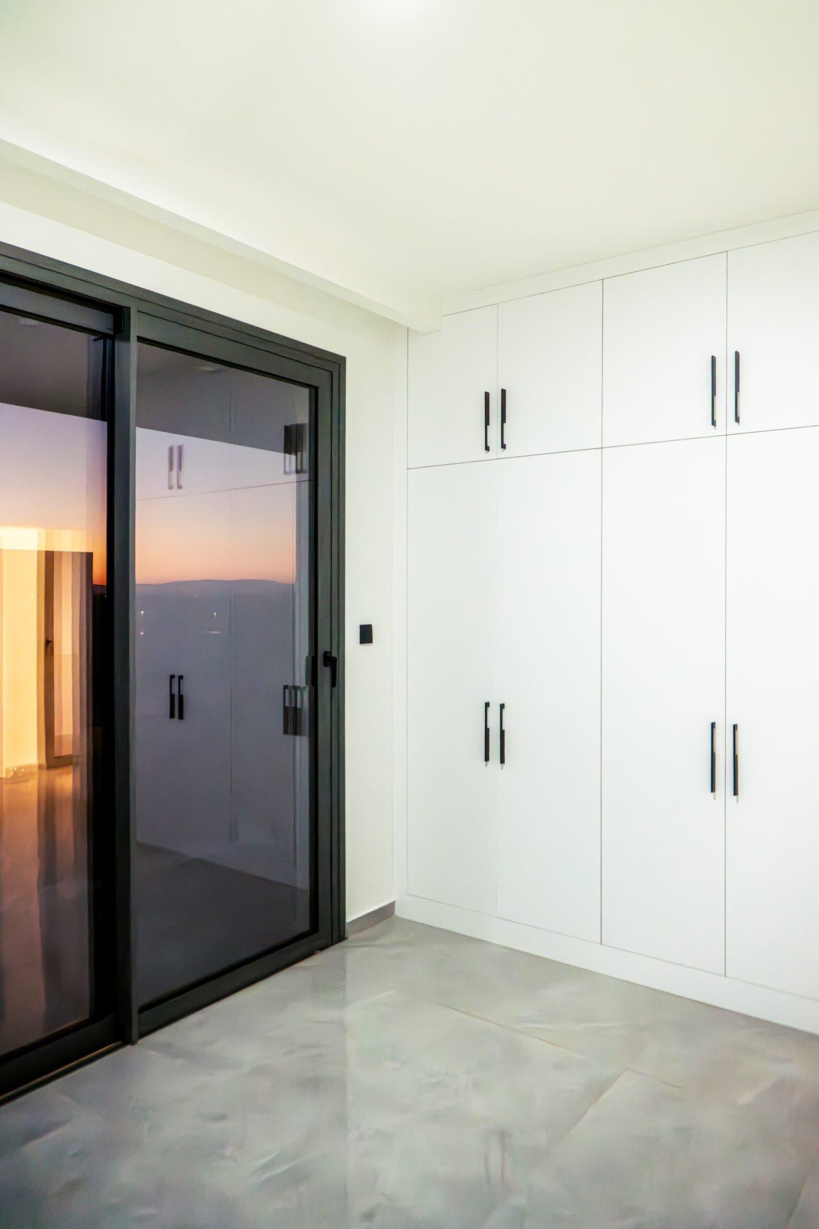 Bedroom with built-in wardrobe at sunset